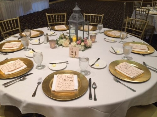 Table settings by IMU, Gold Chargers by Soiree, Table Numbers and Thank you Cards by Zephyr Weddings, and Centerpieces by Racehorse Royalty, Chivari Chairs by AeroRental