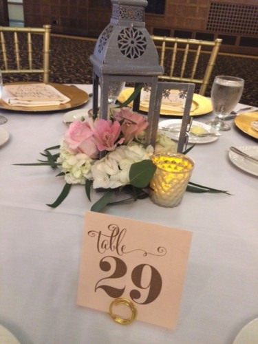 Table settings by IMU, Gold Chargers by Soiree, Table Numbers and Thank you Cards by Zephyr Weddings, and Centerpieces by Racehorse Royalty, Chivari Chairs by AeroRental