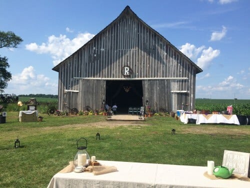 The ceremony and the wedding dance was held in one of the barns on the family farm property. The tables were adorned with lace, doilies, lanterns, and unique knick knacks. The tablecloths were set at random angles on purpose to give the space a rustic look.