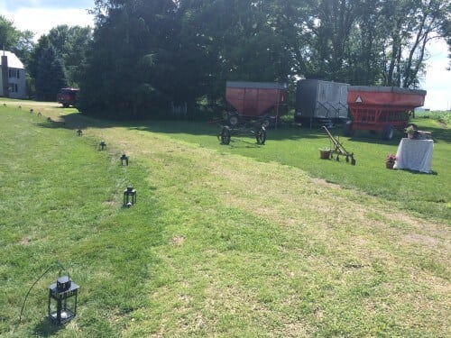 A path lined with lanterns led guests to the ceremony. Farm equipment helped to camouflage the restrooms trailer. 