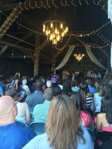 Obsessive worthy mason jar & crystal adorned wagon wheel chandeliers. Custom made by the bride's uncle. Amazing. 