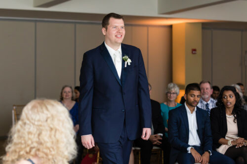 Groom walking down the aisle