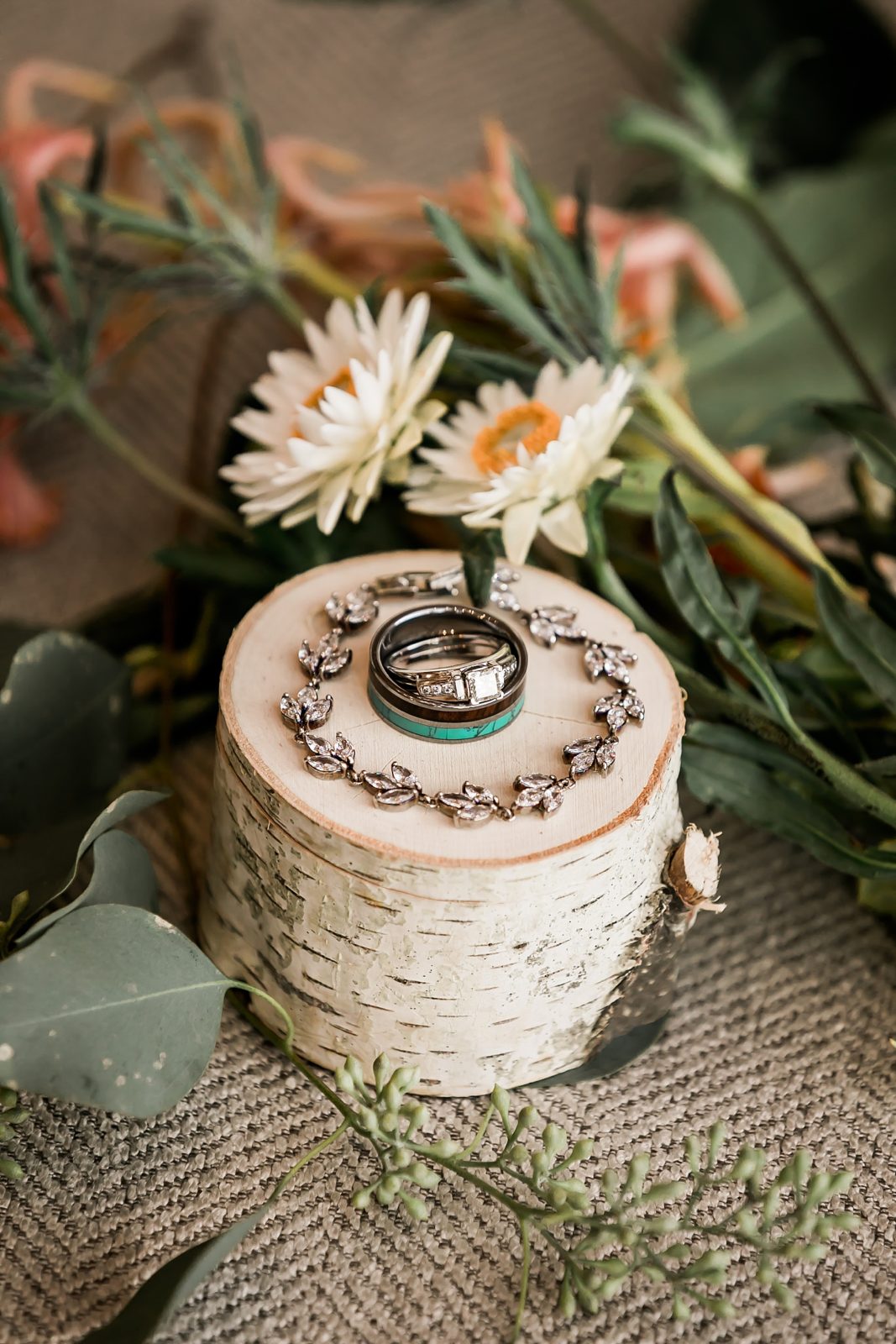 Bride's wedding jewelry on log