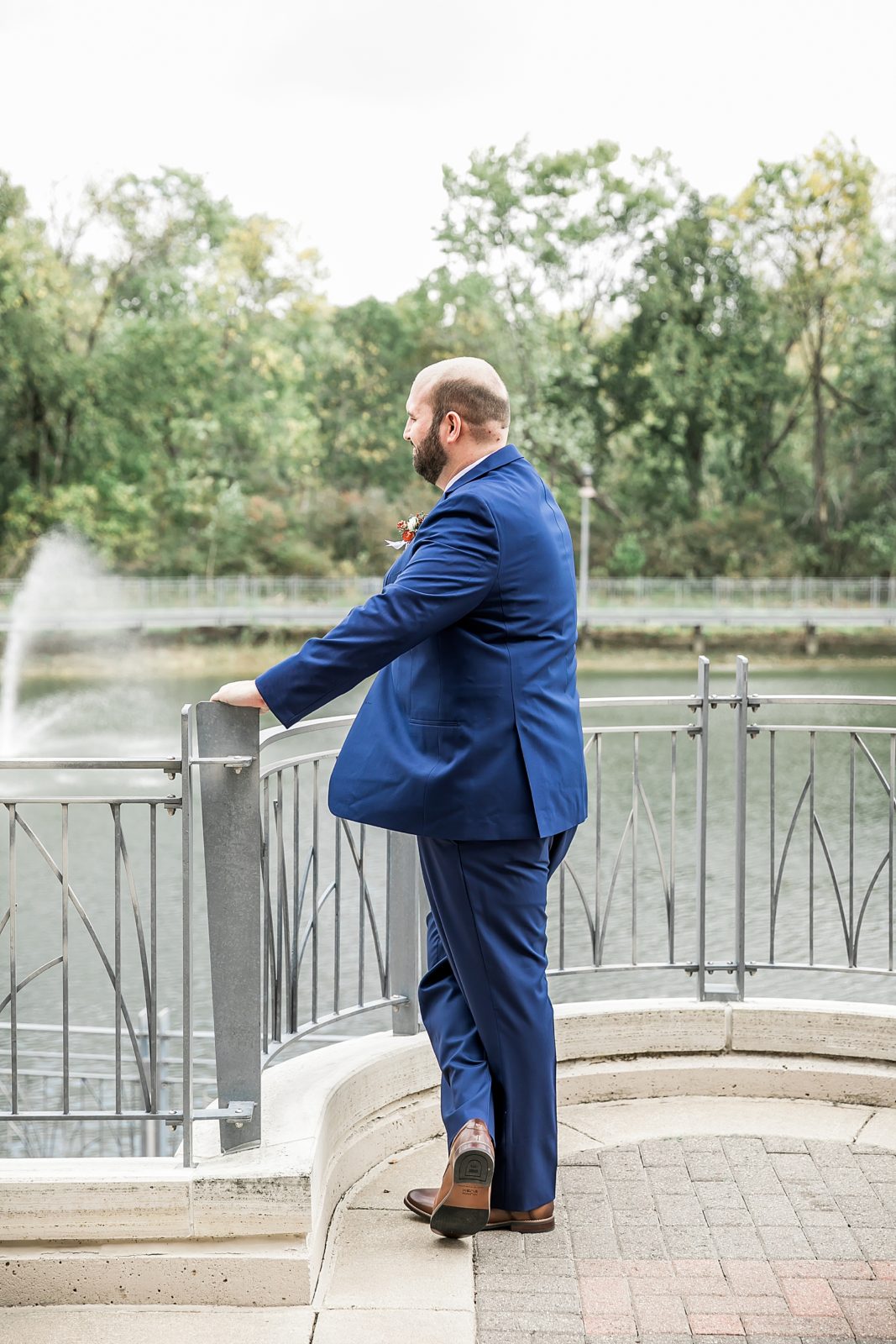 groom looking over water