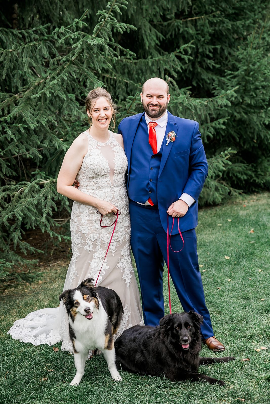 bride and groom with pets in park