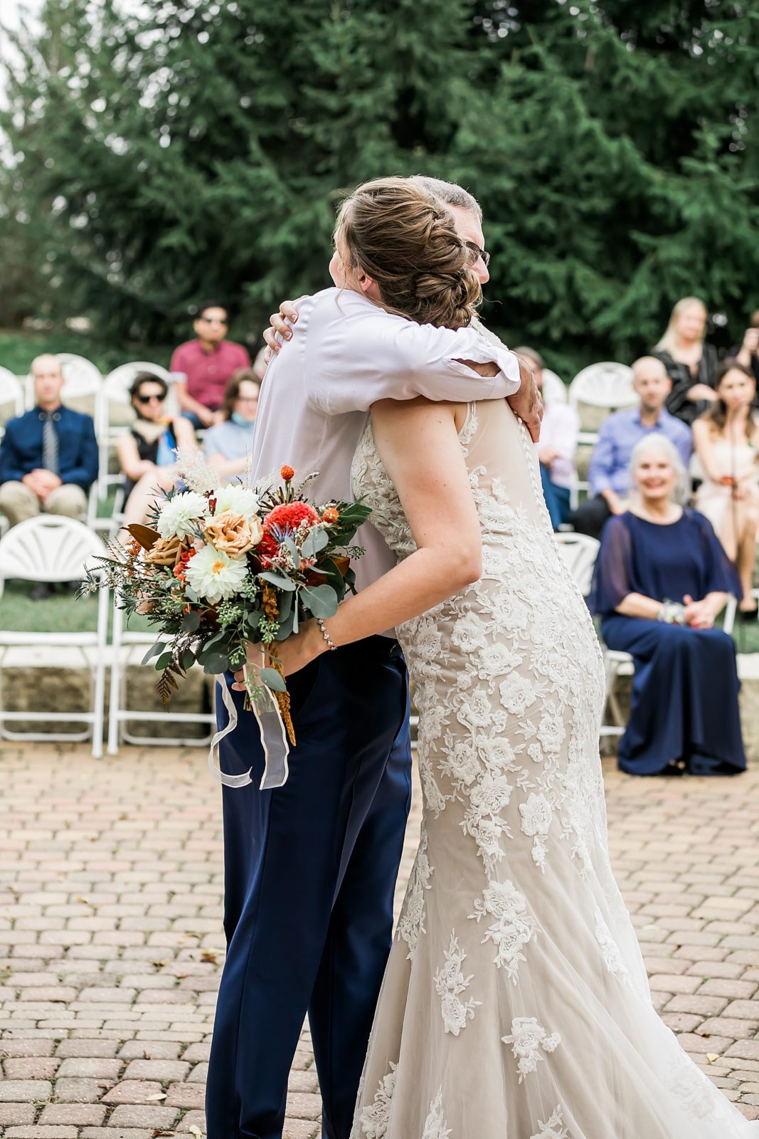 bride hugging father after he walks her down aisle