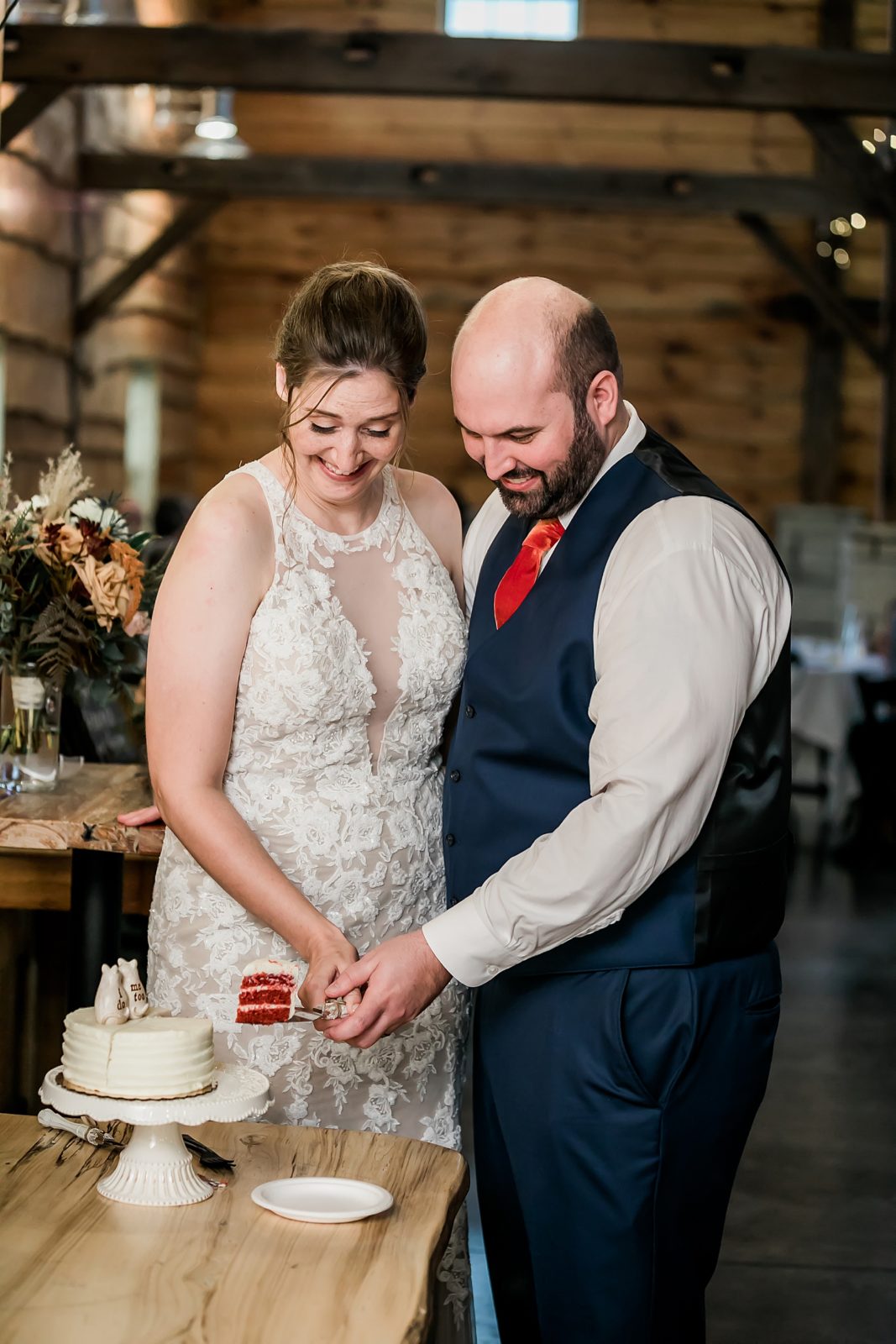 bride and groom cut red velvet cake