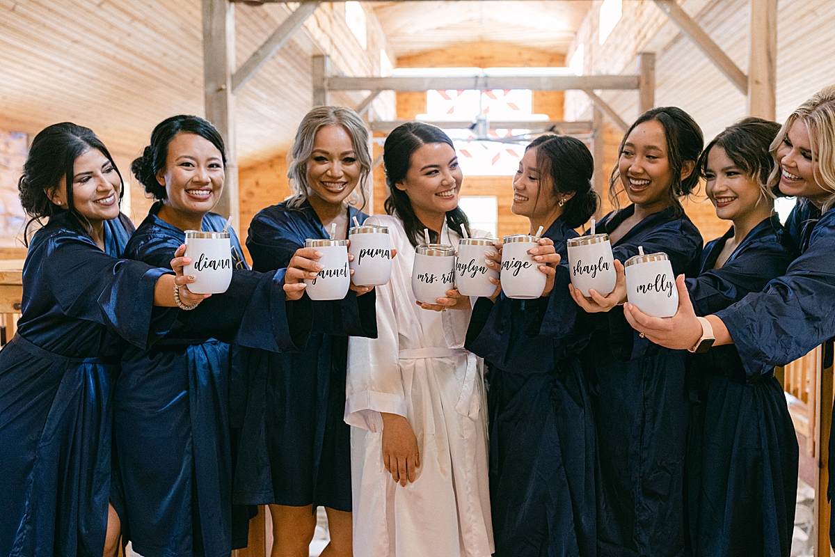 bridesmaids in blue silk robes with wine thermoses