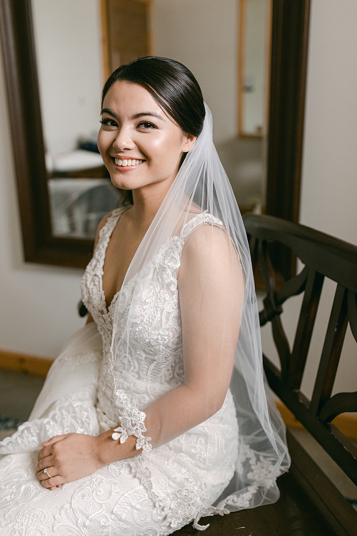 bride smiling at camera while getting ready