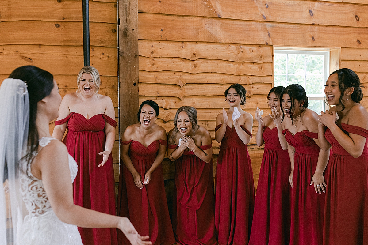 excited bride and bridesmaids first look