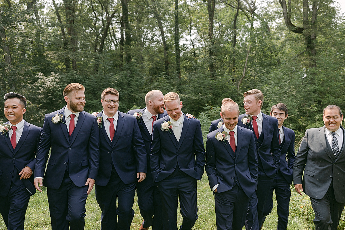 groom's party walking together in navy blue suits