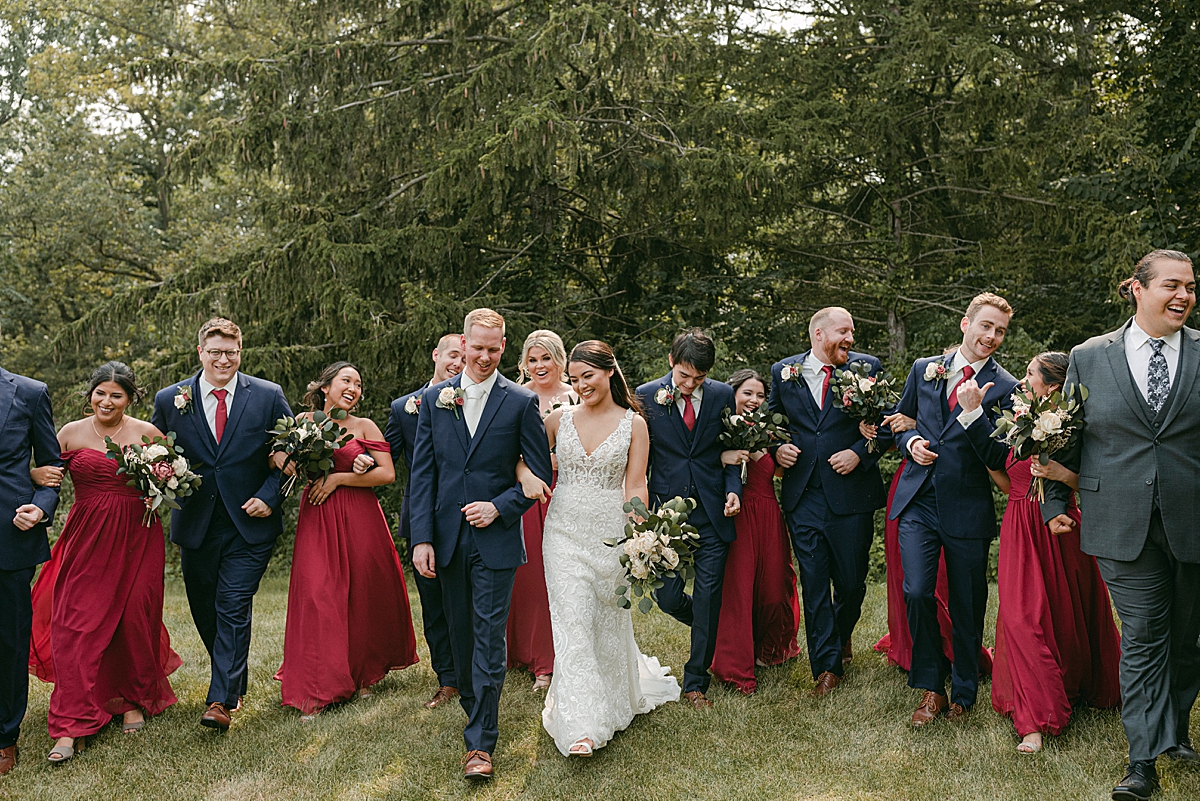 red and navy blue wedding party walking together
