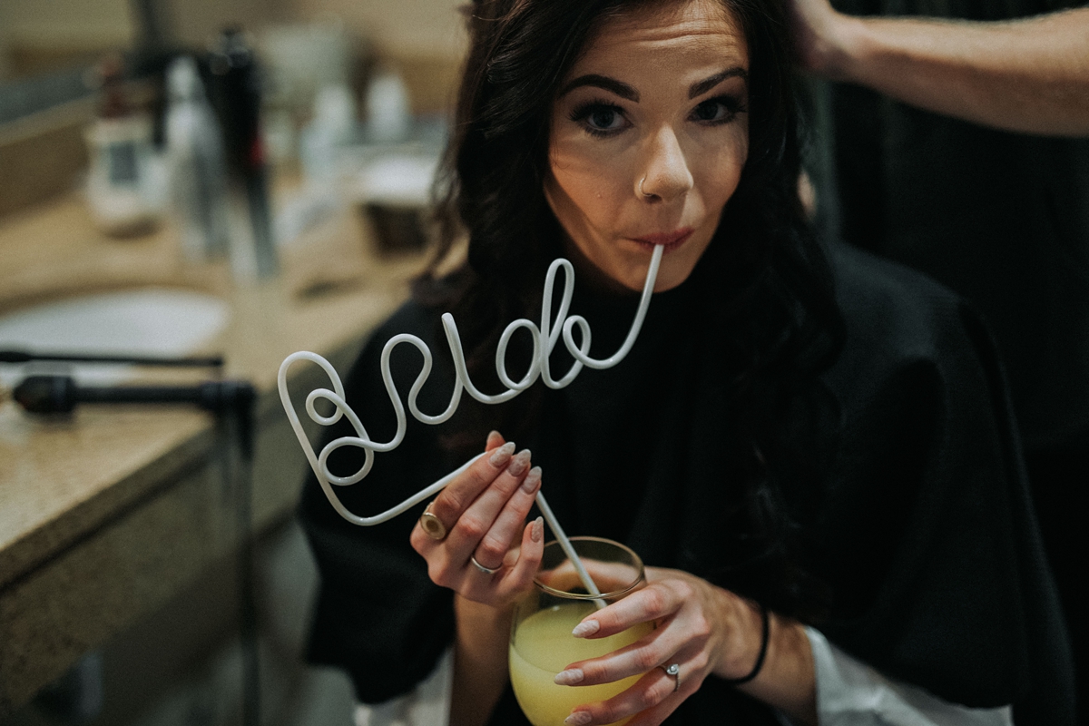 Bride sipping mimosa from BRIDE crazy straw