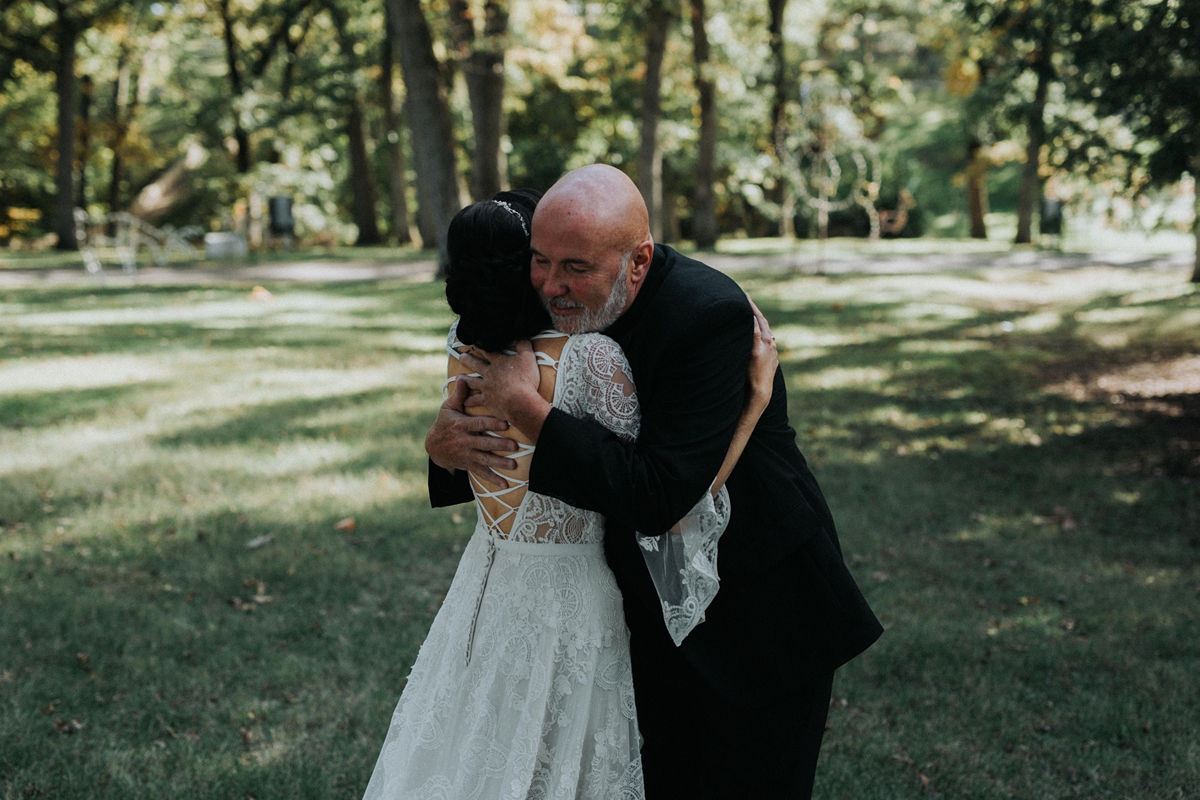 father hugging daughter before her wedding