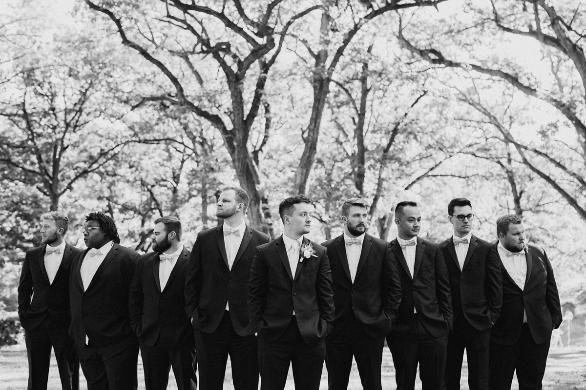 groom and groomsmen in park portrait black and white