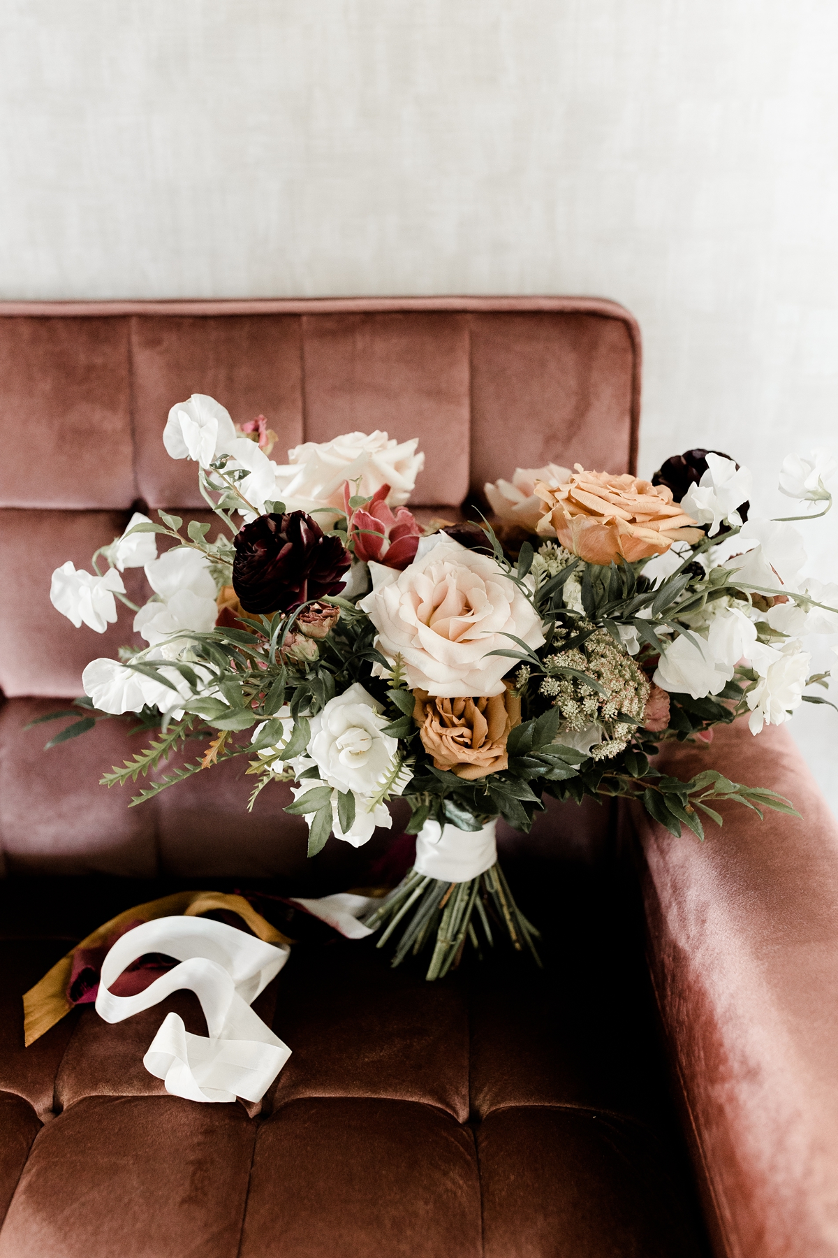 bridal rose bouquet on pink velvet couch