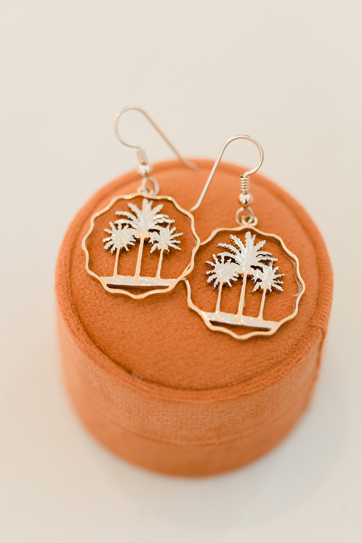 Three palm trees gold earrings for bride on wedding day on orange jewelery box