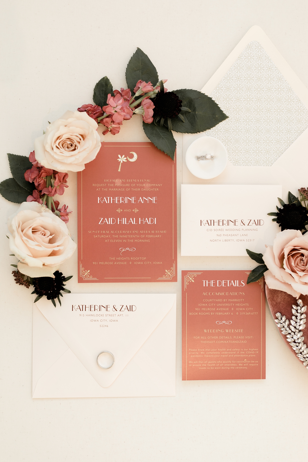 White and pink wedding invitation with roses flatlay
