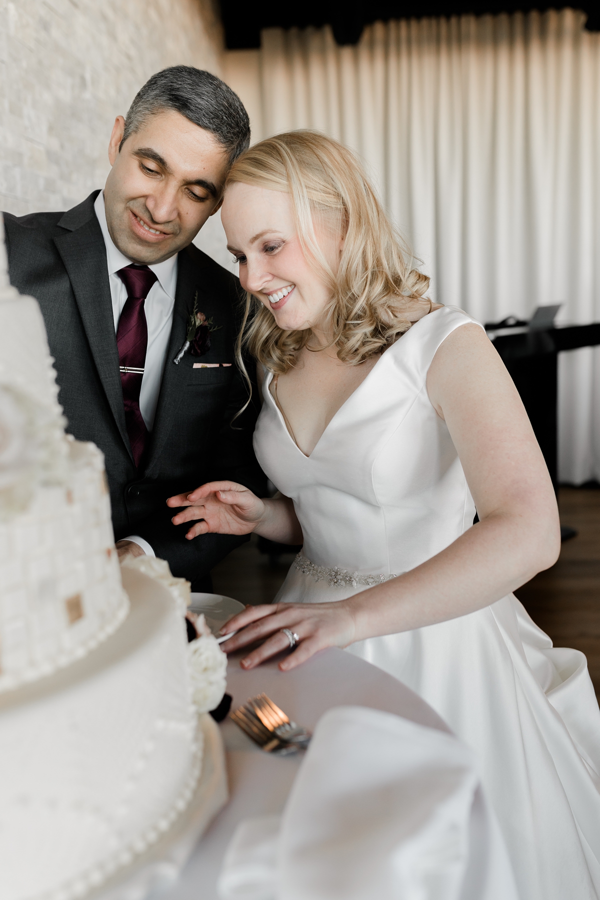 cute bride and groom cutting cake