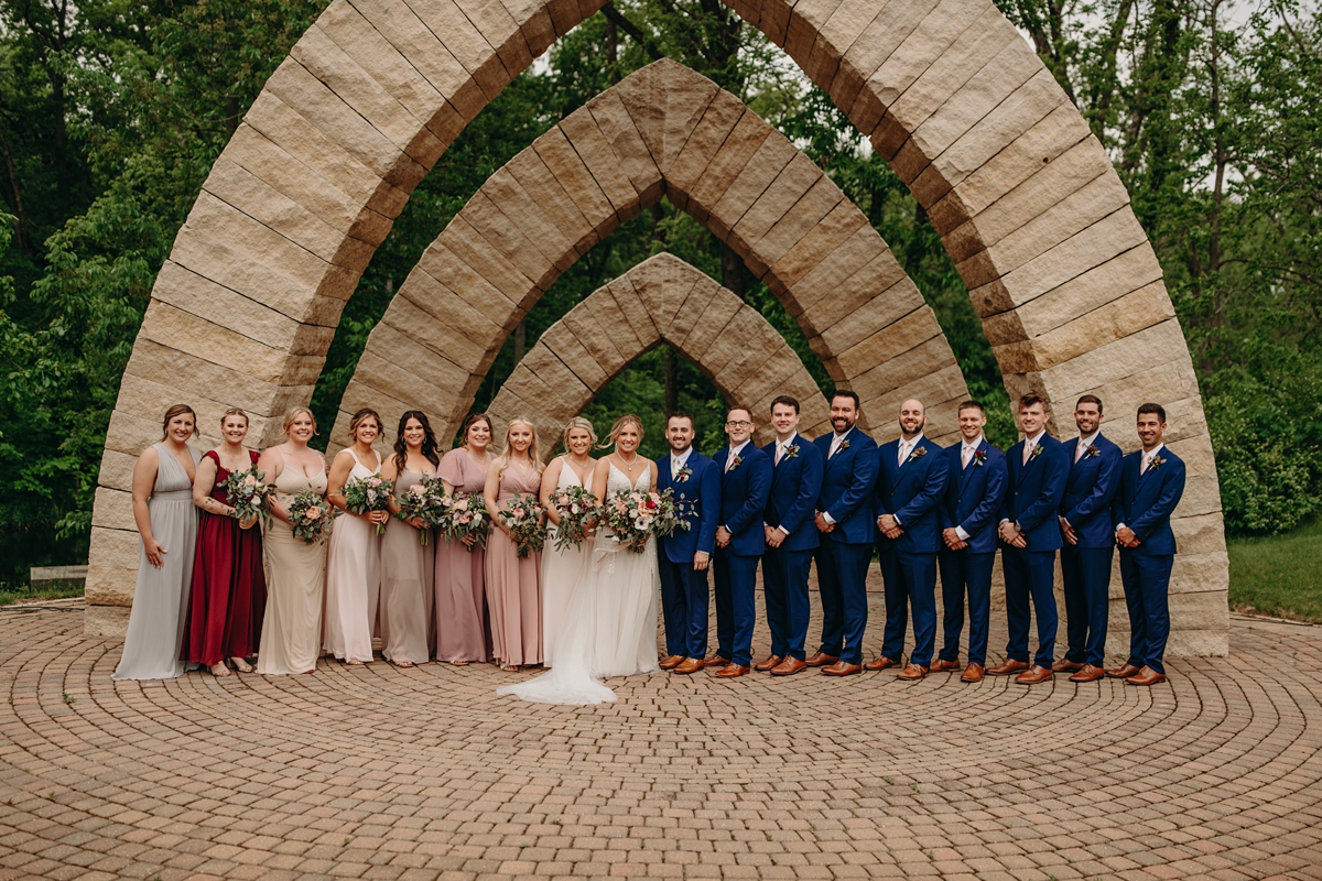 Bridal party under arches at Celebration Farm Wedding Iowa City