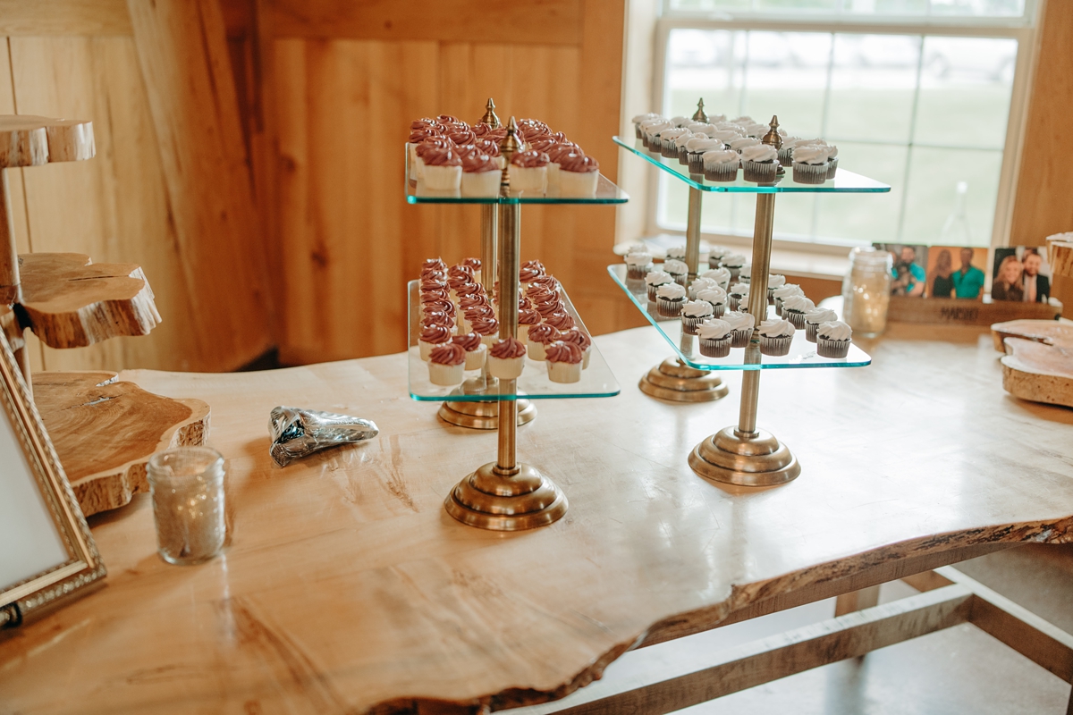 Cupcake glass display shelves at at Celebration Farm Wedding Reception Iowa City