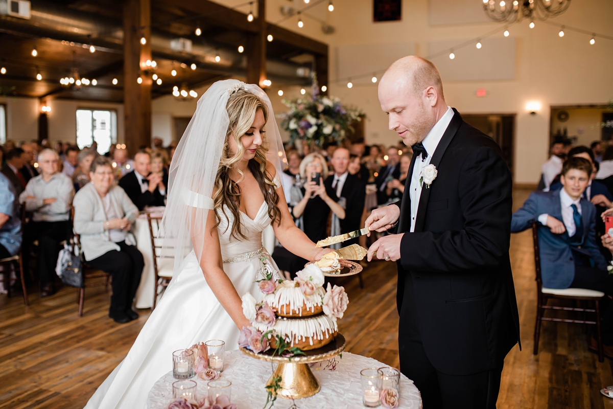 Bride and groom cutting double layer bundt wedding cake
