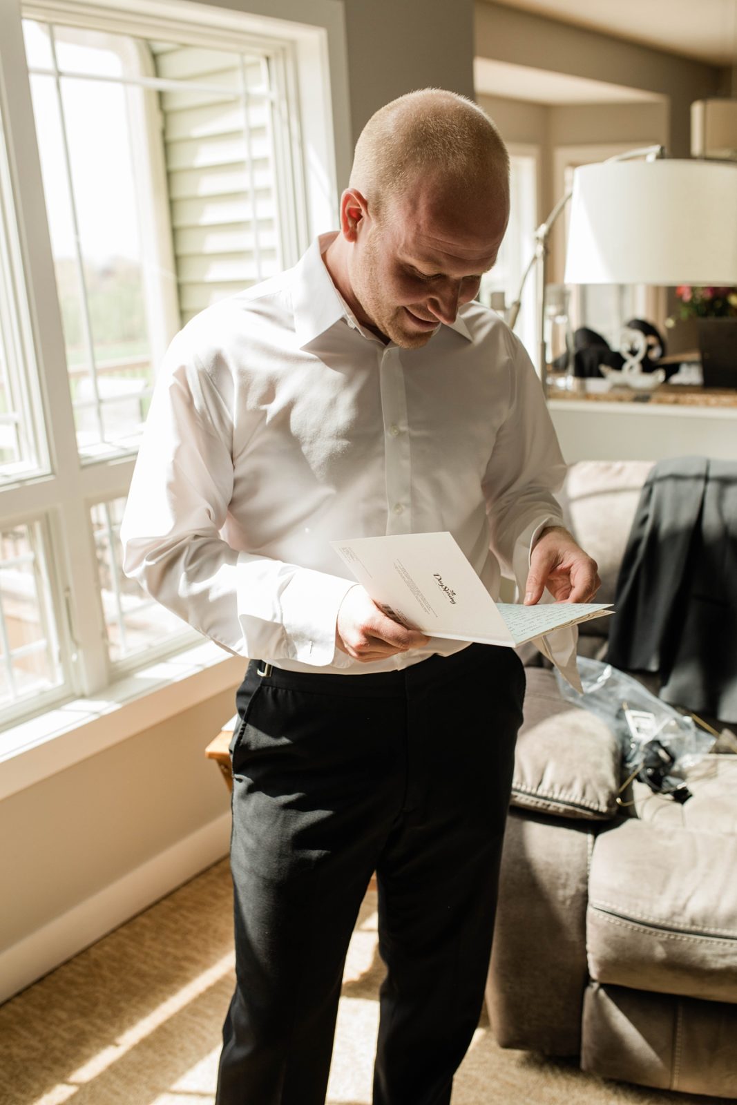 Groom reading letter from bride before ceremony.