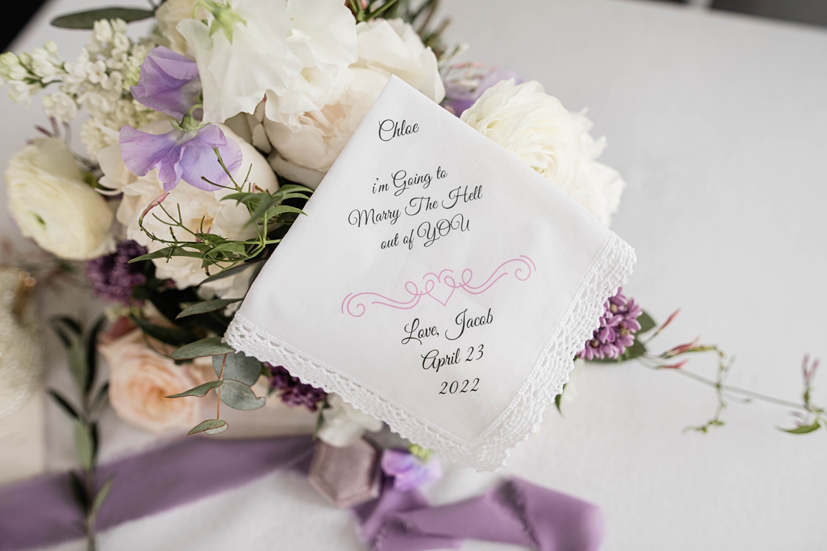 Bride's linen handkerchief embroidered with sweet note from groom.