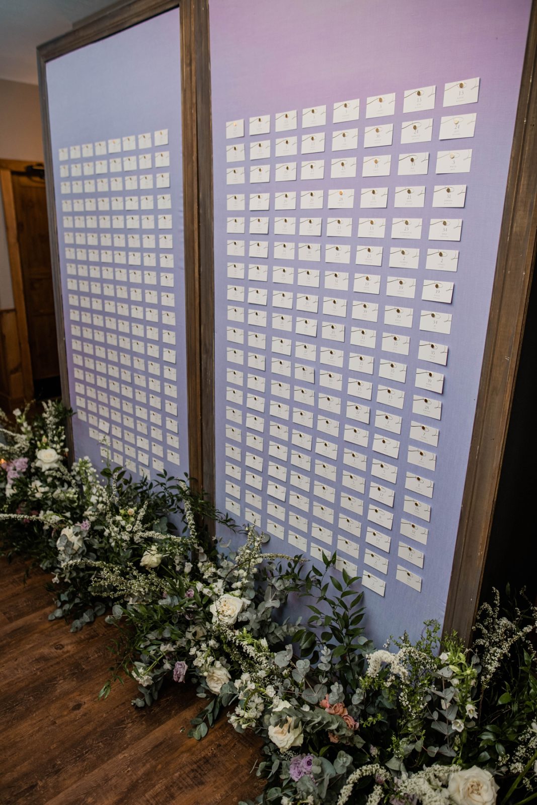 Purple wedding reception guest seating chart.
