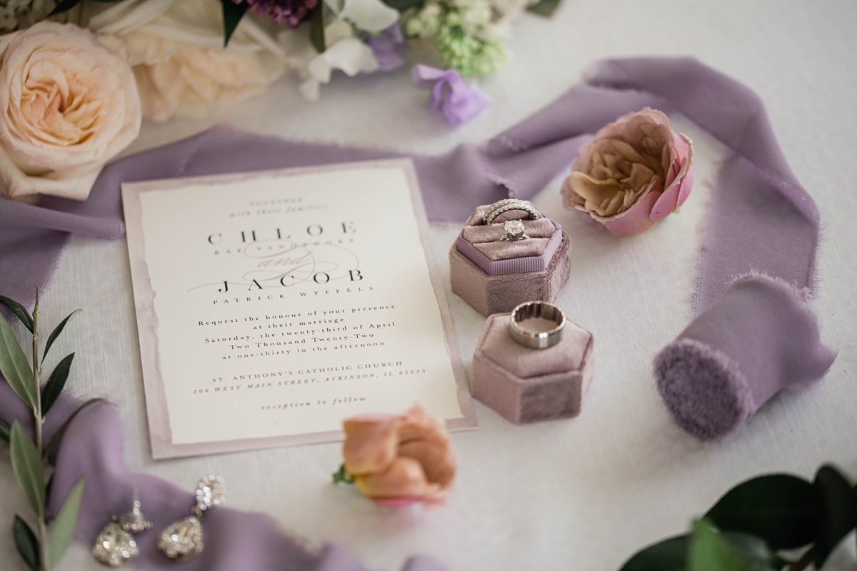 Lavender and purple wedding invitation and details flat lay