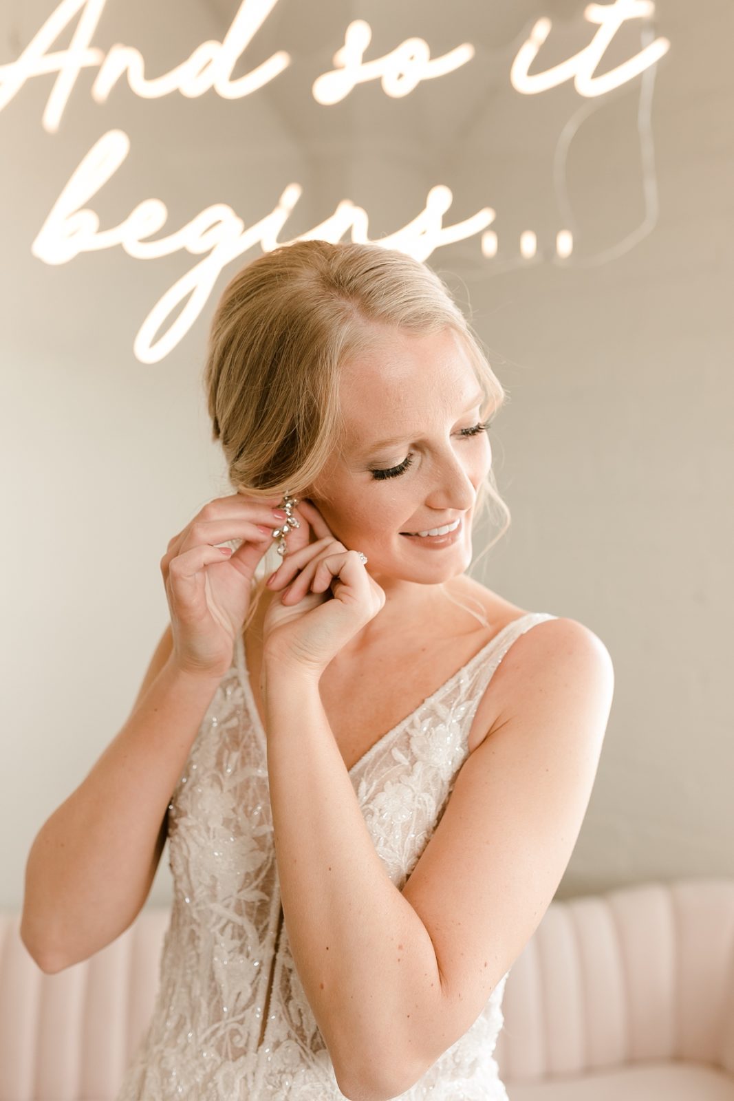 Cedar Rapids Iowa Blush Pink Harmac Wedding bride puts on earrings