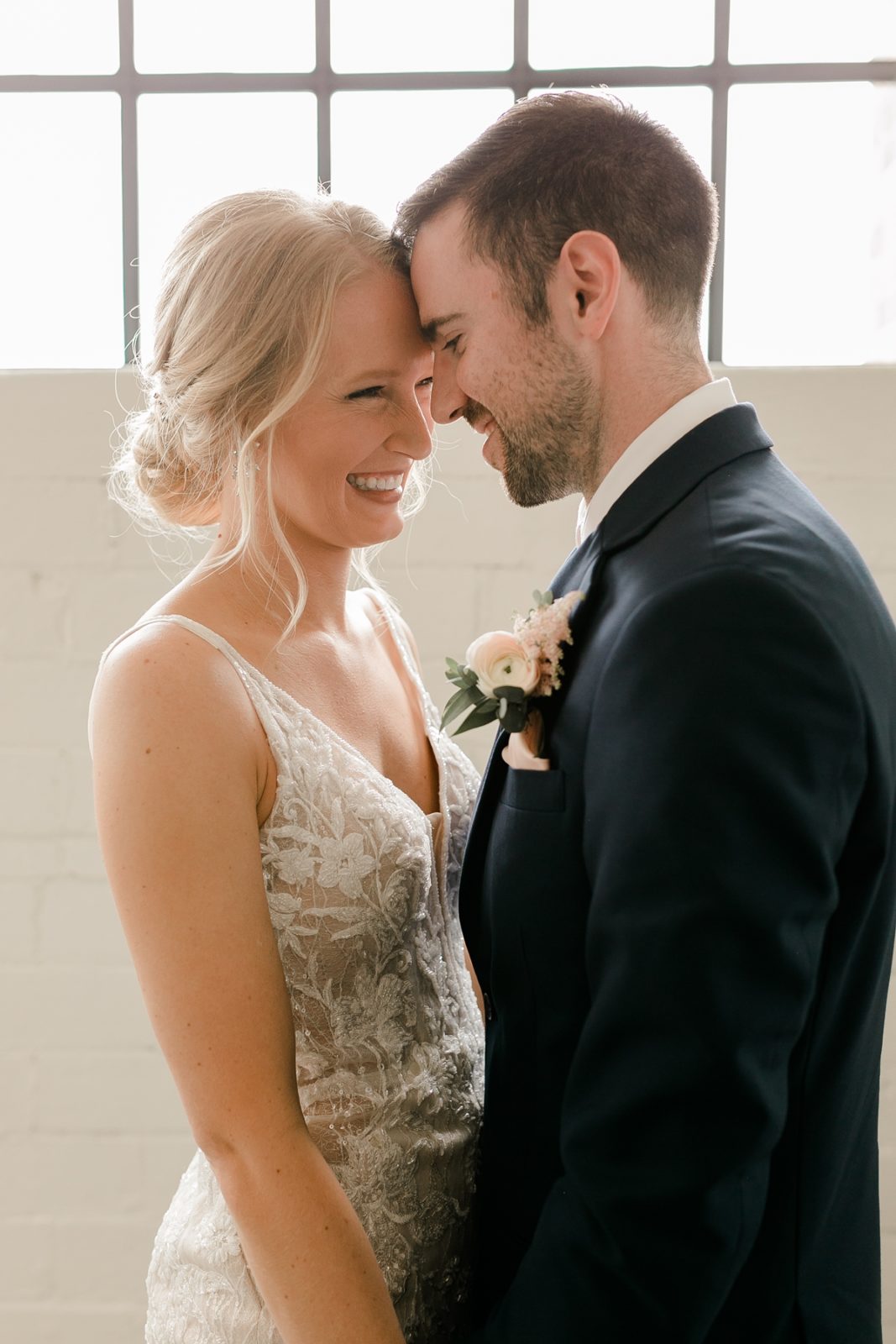 Cedar Rapids Iowa Blush Pink Harmac Wedding bride and groom smiling at eachother