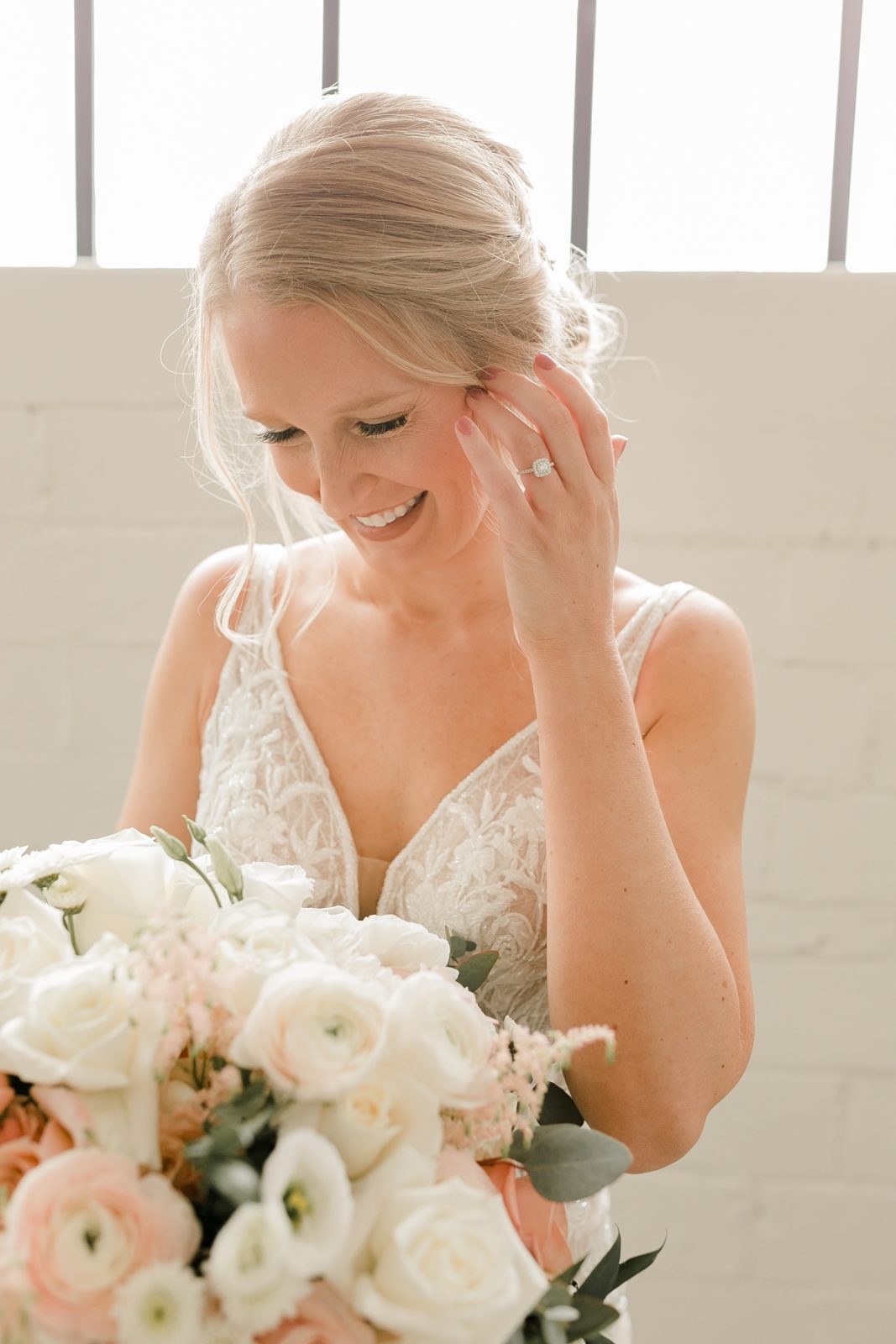 Cedar Rapids Iowa Blush Pink Harmac Wedding bride looking down at white bouquet