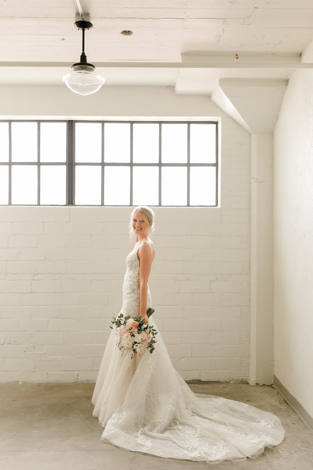 Cedar Rapids Iowa Blush Pink Harmac Wedding bride smiling at camera before wedding