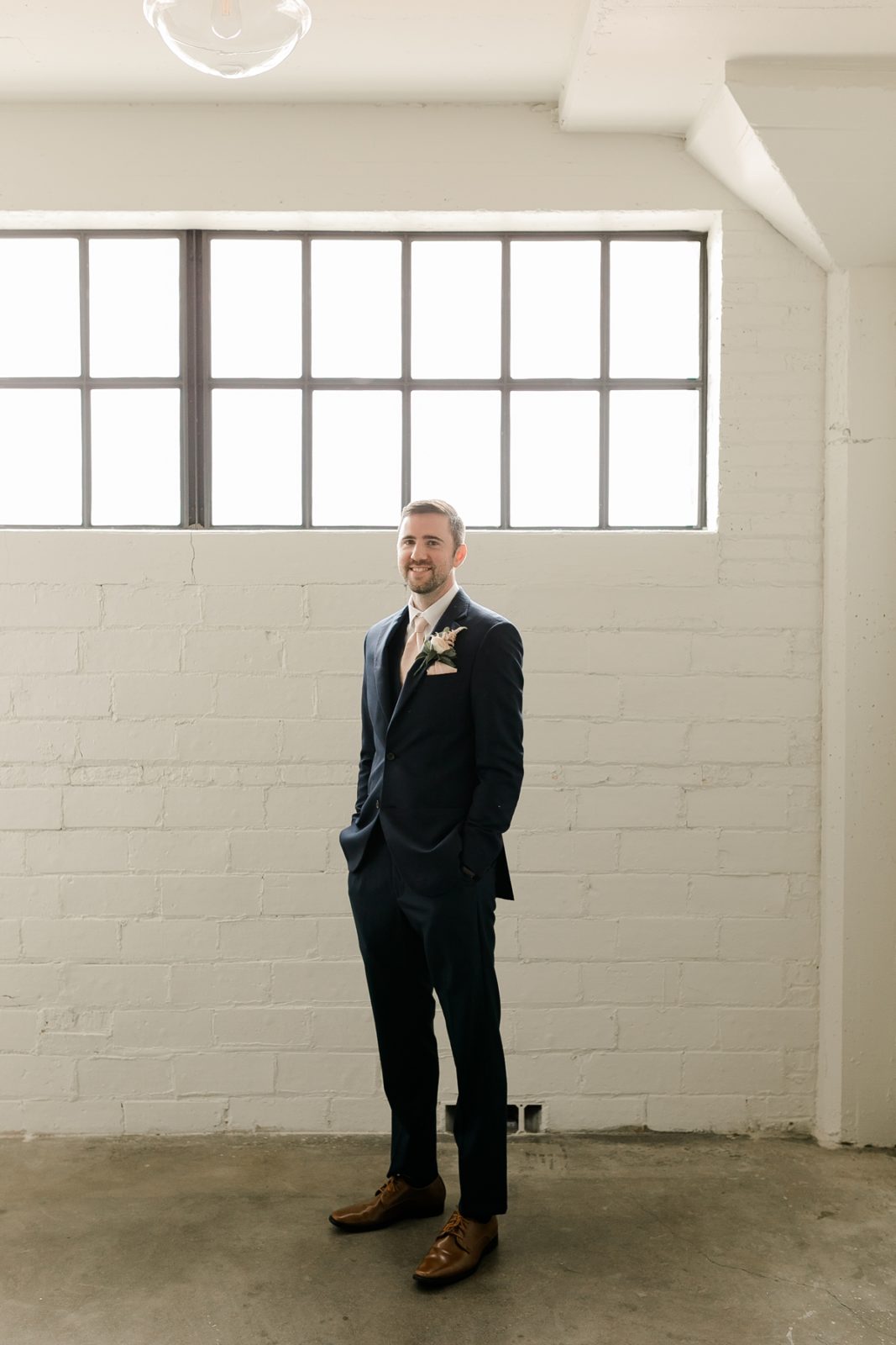 Cedar Rapids Iowa Blush Pink Harmac Wedding groom smiling at camera before wedding