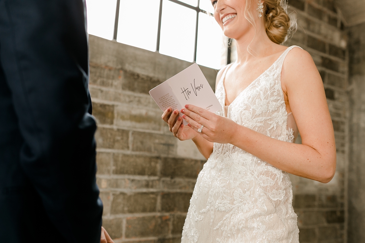 Cedar Rapids Iowa Blush Pink Harmac Wedding bride reading from vow book