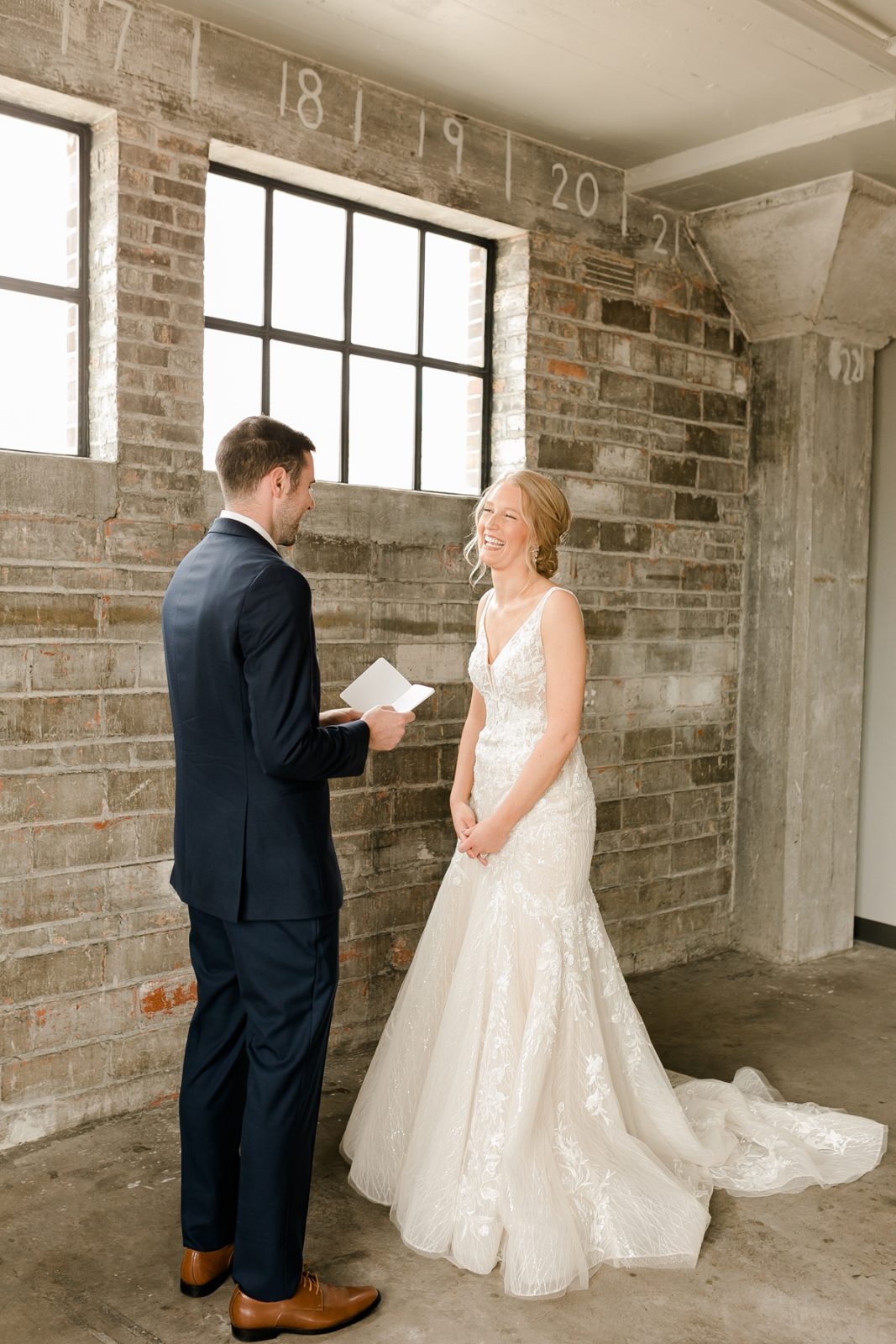 Cedar Rapids Iowa Blush Pink Harmac Wedding groom reading from vow book