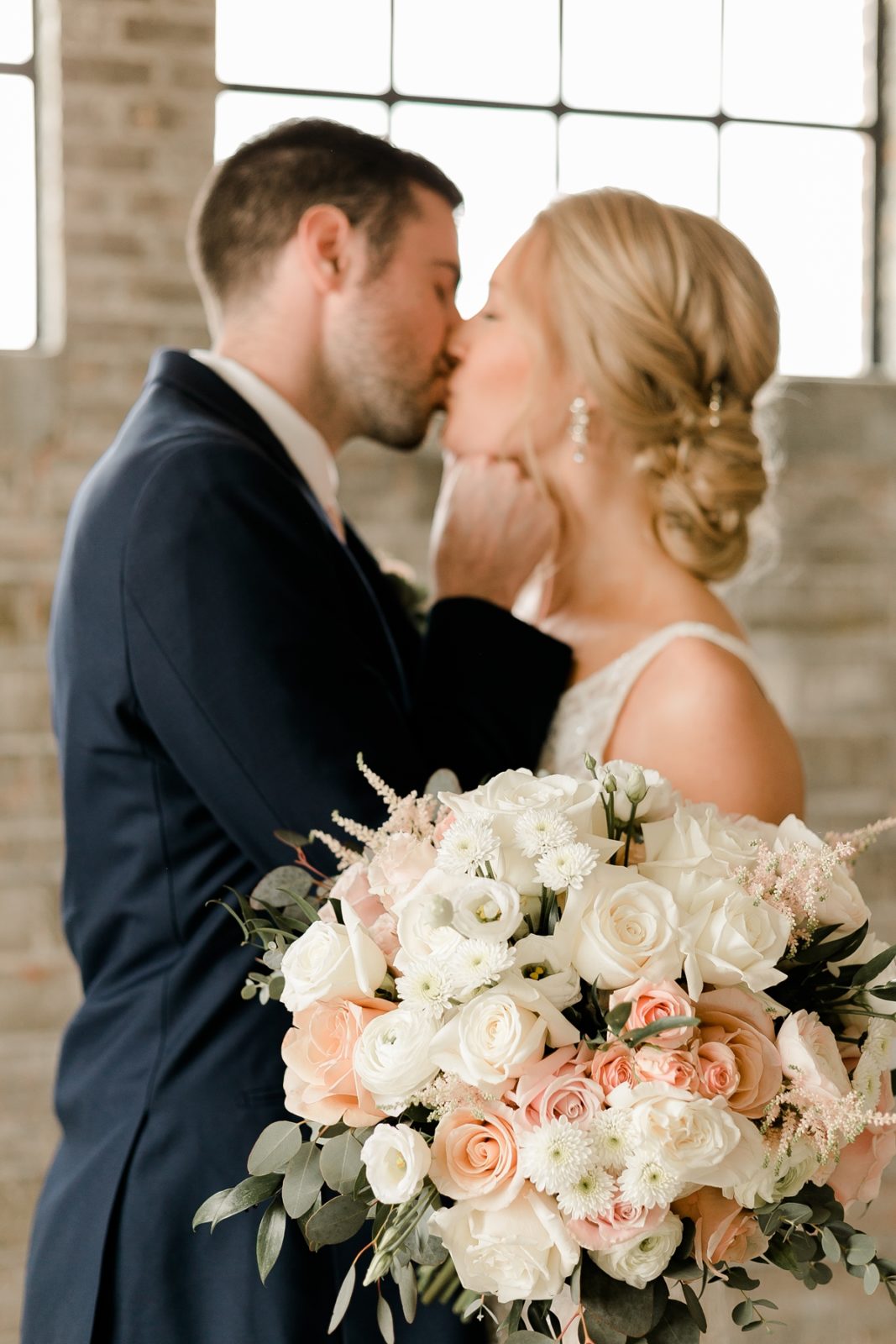 Cedar Rapids Iowa Blush Pink Harmac Wedding bride and groom kiss