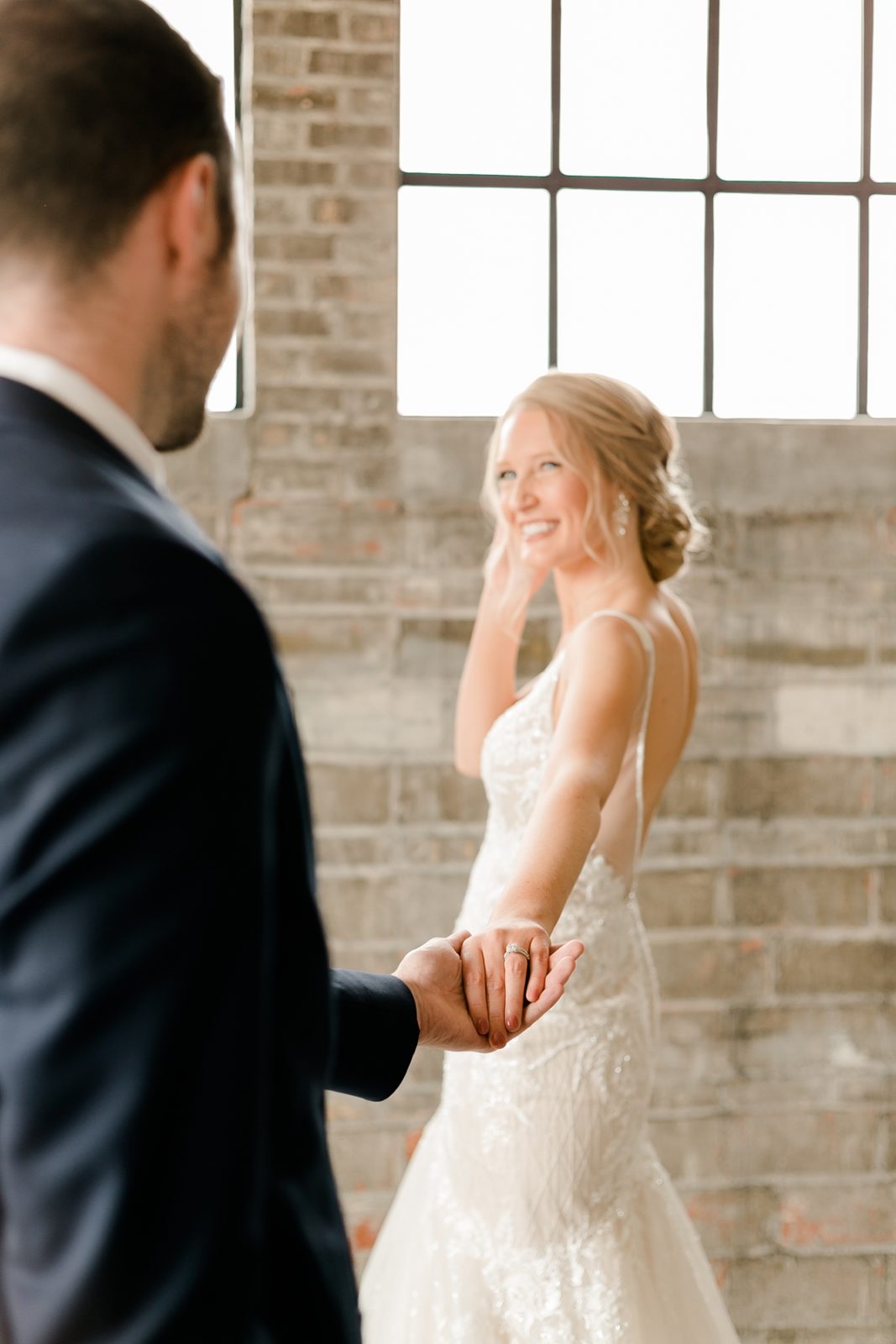 Cedar Rapids Iowa Blush Pink Harmac Wedding groom holding bride's hand