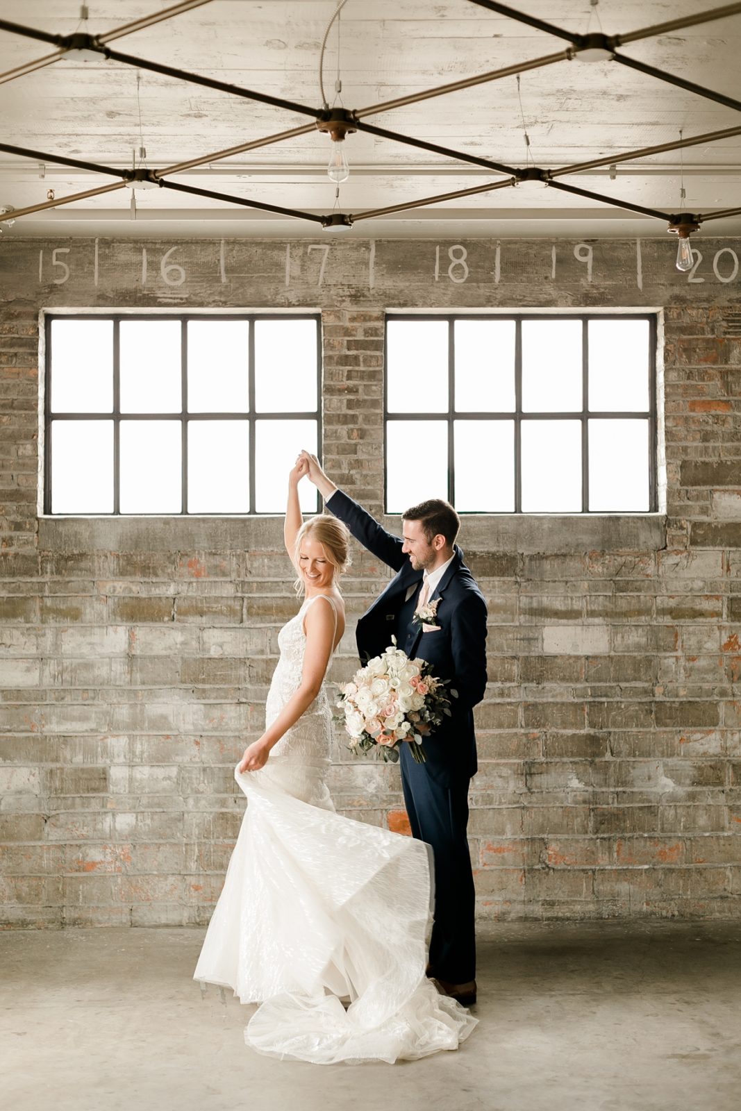 Cedar Rapids Iowa Blush Pink Harmac Wedding groom dancing with bride before wedding