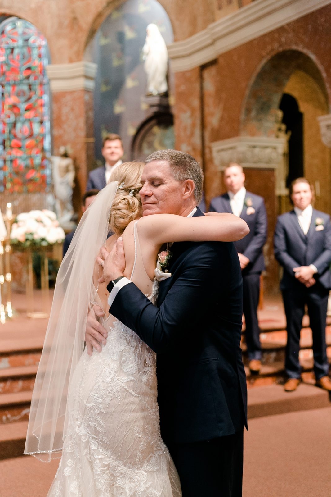 St Patricks Catholic Church In Cedar Rapids Wedding bride hugs father in aisle