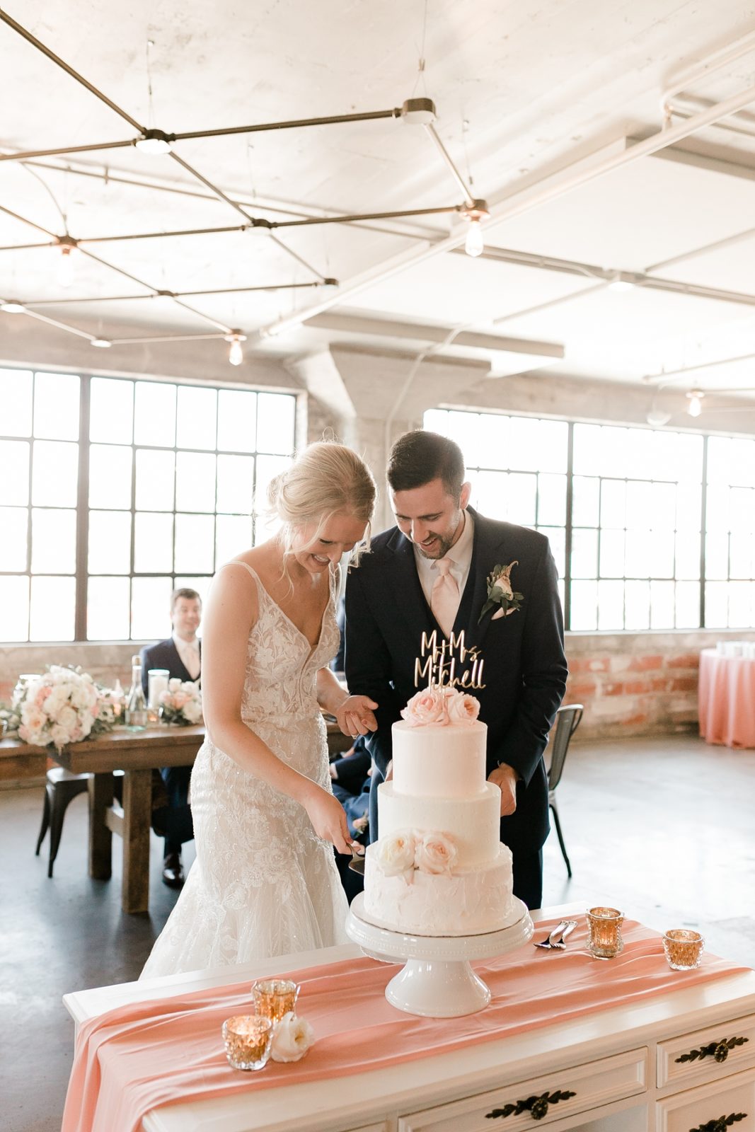 Cedar Rapids Iowa Blush Pink Harmac Wedding bride and groom cutting 3 layer cake