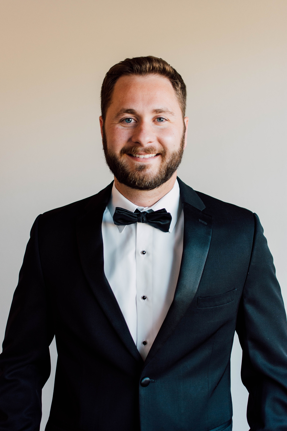 Gathering Barn Williamsburg Iowa Wedding groom with black bow tie