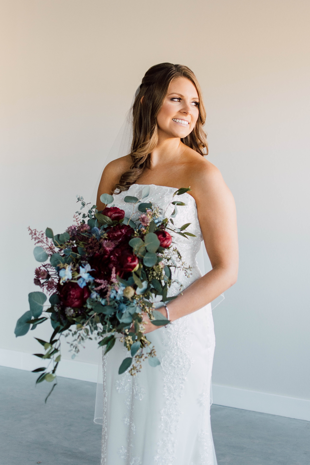 Gathering Barn Williamsburg Iowa Wedding bride with cascading floral bouquet