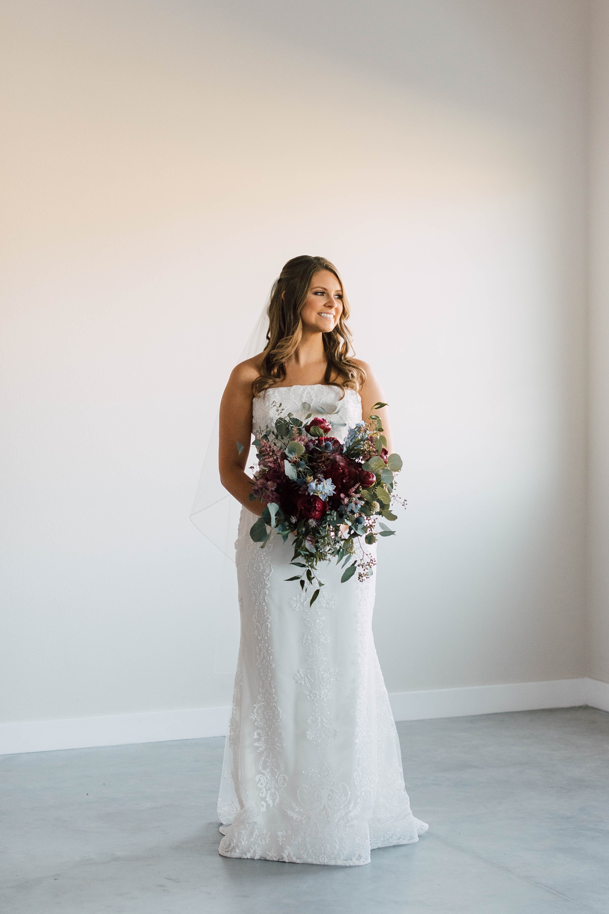 Gathering Barn Williamsburg Iowa Wedding Bride with jewel tone bouquet