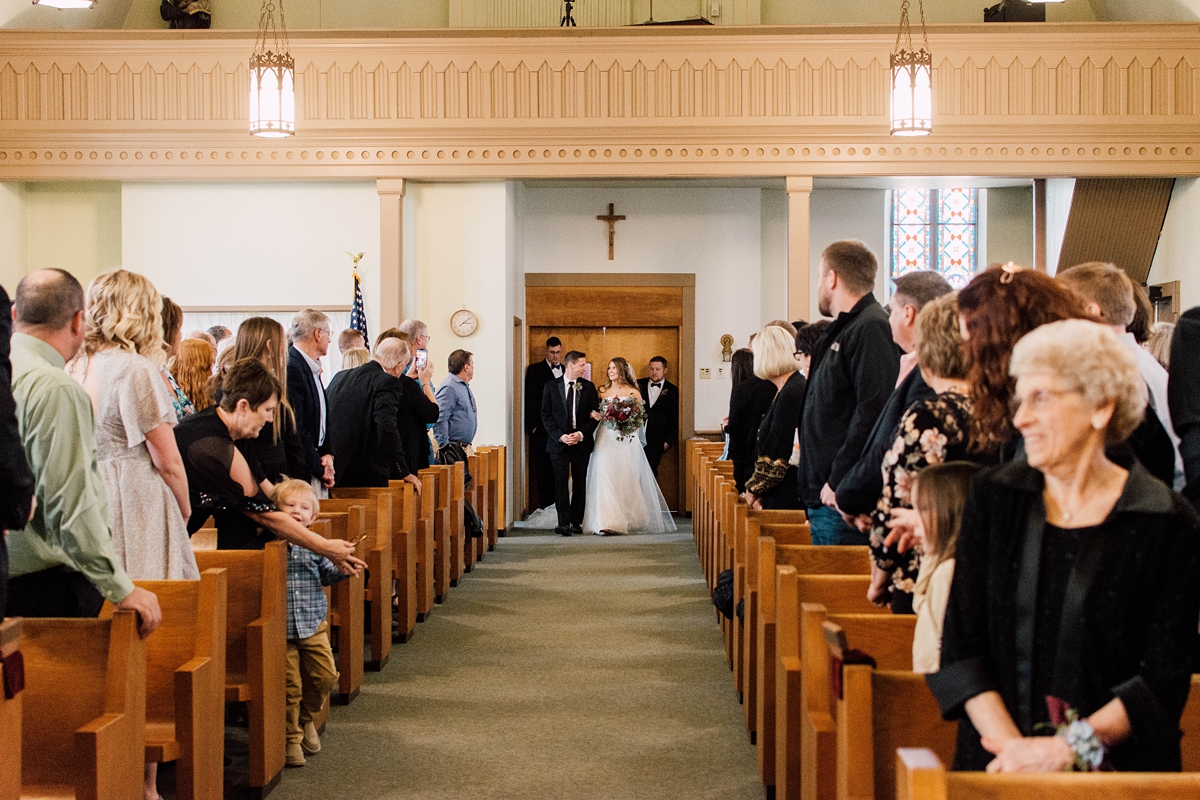 St Peter's Catholic Church in Oxford Iowa bride and father walking down aisle at wedding