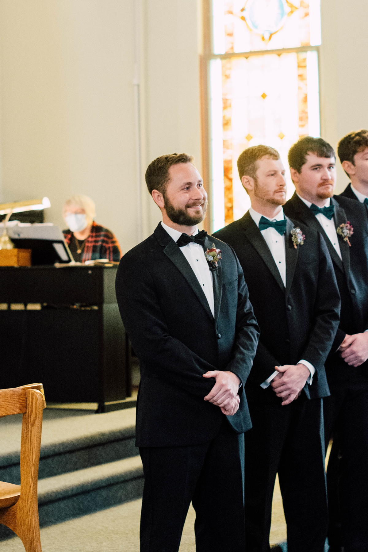 St Peter's Catholic Church in Oxford Iowa wedding - groom watching bride walk down the aisle