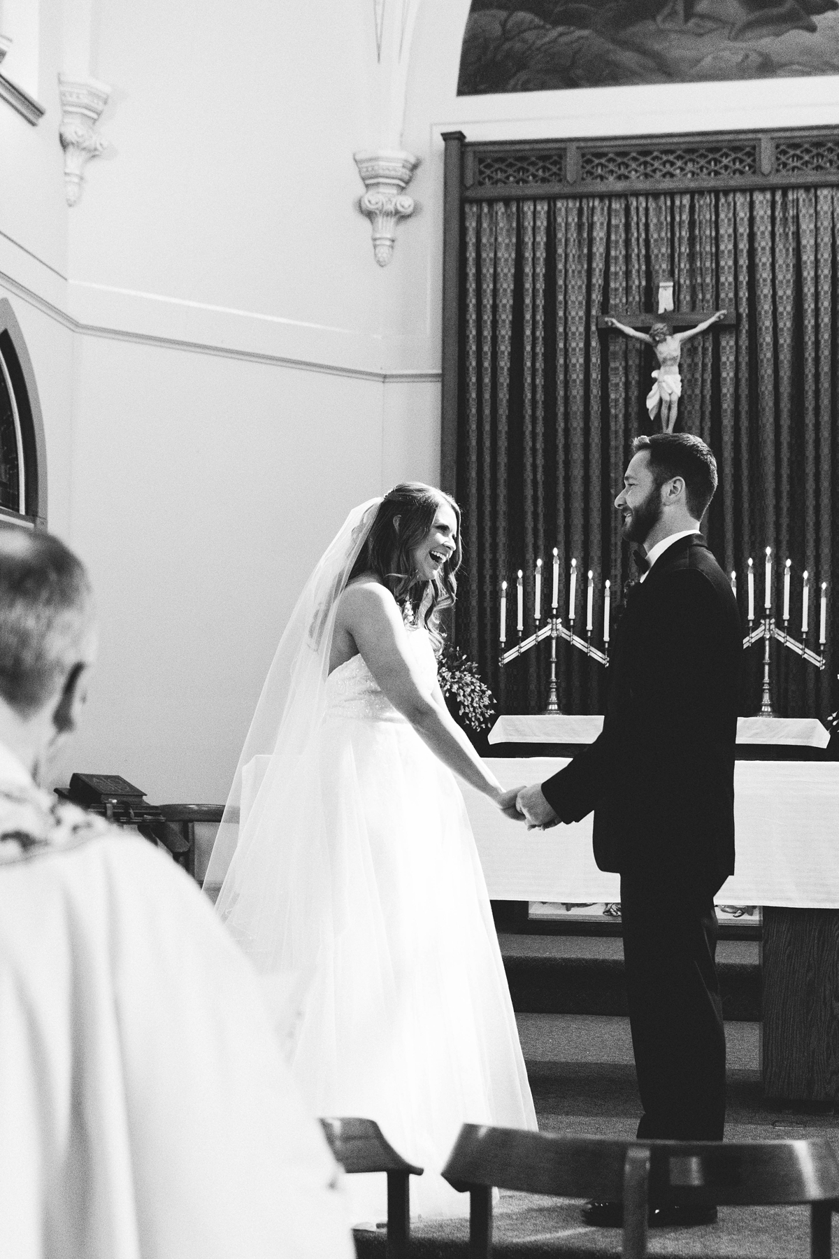 St Peter's Catholic Church in Oxford Iowa bride and groom laughing during wedding ceremony