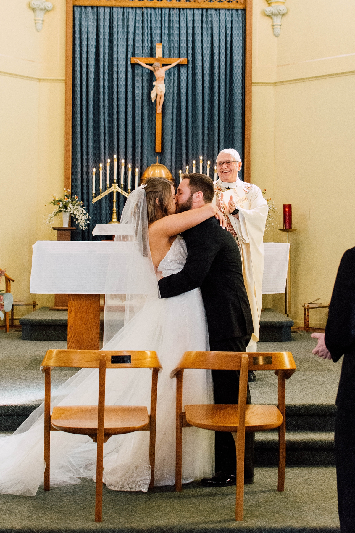 St Peter's Catholic Church in Oxford Iowa bride and groom kiss during wedding ceremony