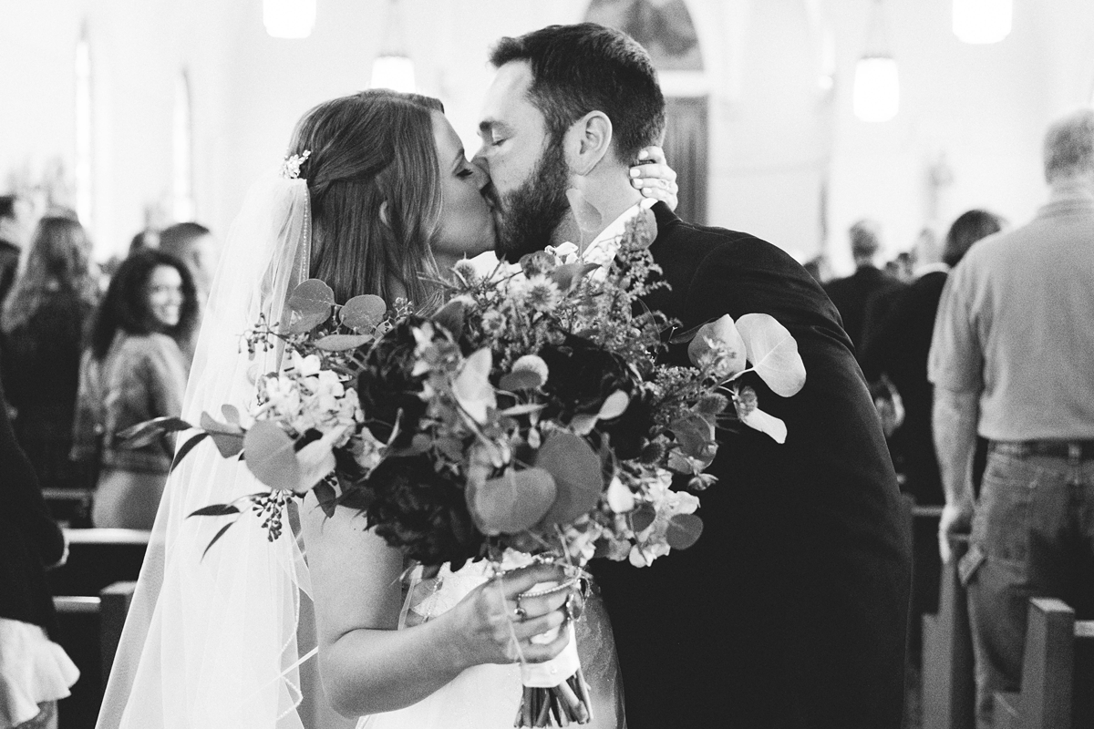 St Peter's Catholic Church in Oxford Iowa bride and groom kiss at wedding